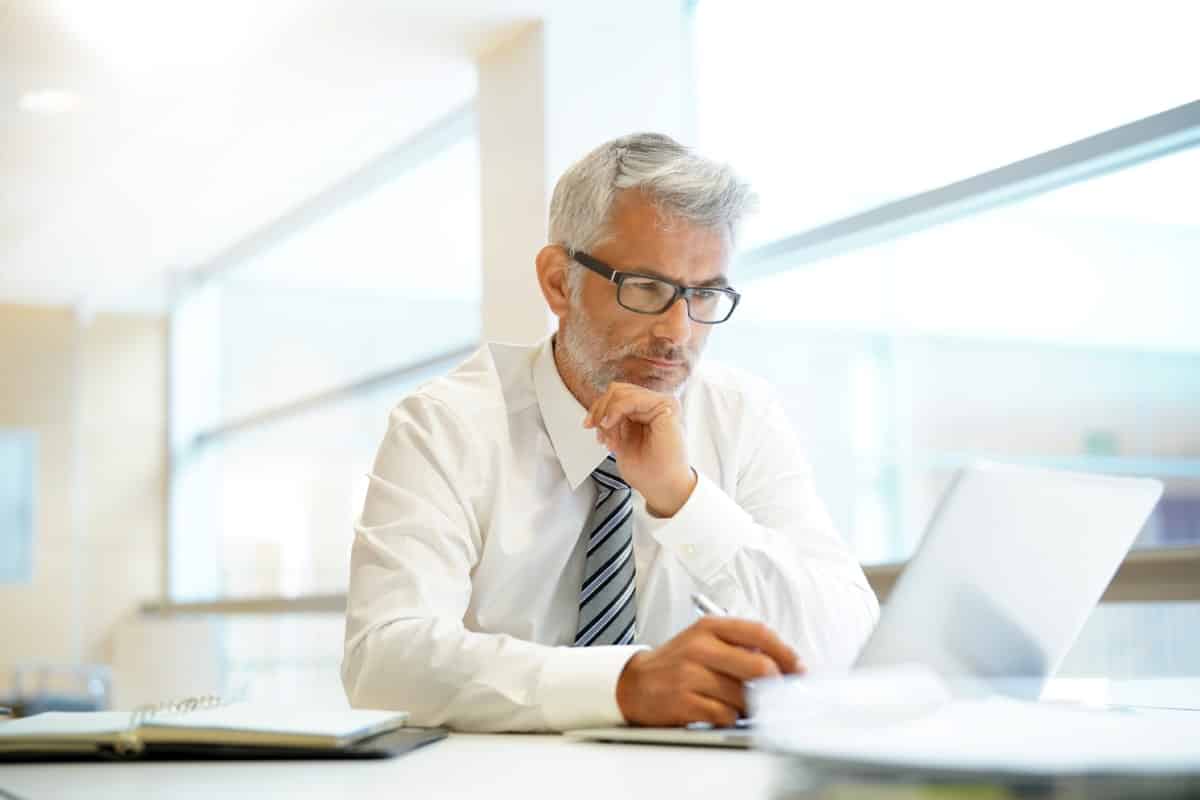 Relaxed mature businessman working in contemporary office